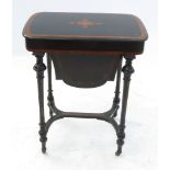 A Victorian ebony work table, having cross banded decoration and central inlay decoration,