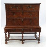 An early 18th century walnut chest on stand, having a boxwood geometric line inlay top,