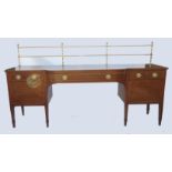 A 19th century mahogany break bow front sideboard, with two brass rail gallery over,