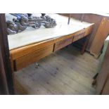 A Gordon Russell teak sideboard, fitted three short drawers to the frieze,
