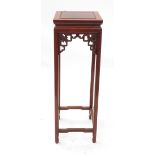 A Chinese square jardiniere stand, having carved frieze, raised on four legs united by stretchers,