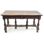 An Antique oak three plank table, with carved frieze fitted with three drawers,