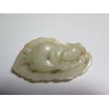 A Carved Jade Pendant in the form of a standing lady and reverse carved as foliage