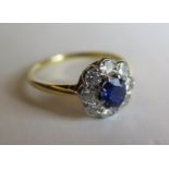 A Sapphire and Diamond Cluster Ring, .4ct sapphire and .64 diamond