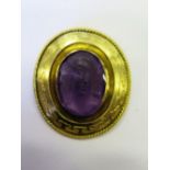 A Carved Amethyst and Gold Brooch decorated with bust of classical lady