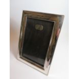 A Heavy Chinese Silver Photograph Frame with hardwood easel back