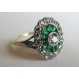 An Emerald and Diamond Cluster Ring, .65ct diamonds