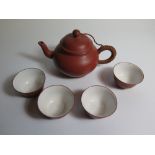 A Chinese Terracotta Tea Pot and four bowls