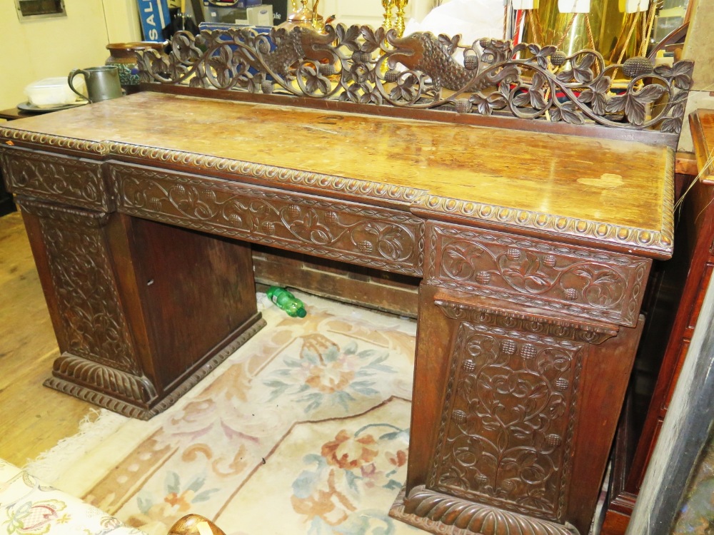 An Anglo Indian Carved Padouk Wood Twin Pedestal Desk. 153 x 57cm