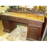 An Anglo Indian Carved Padouk Wood Twin Pedestal Desk. 153 x 57cm