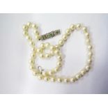 An Pearl Necklace with 18ct white gold and emerald set clasp