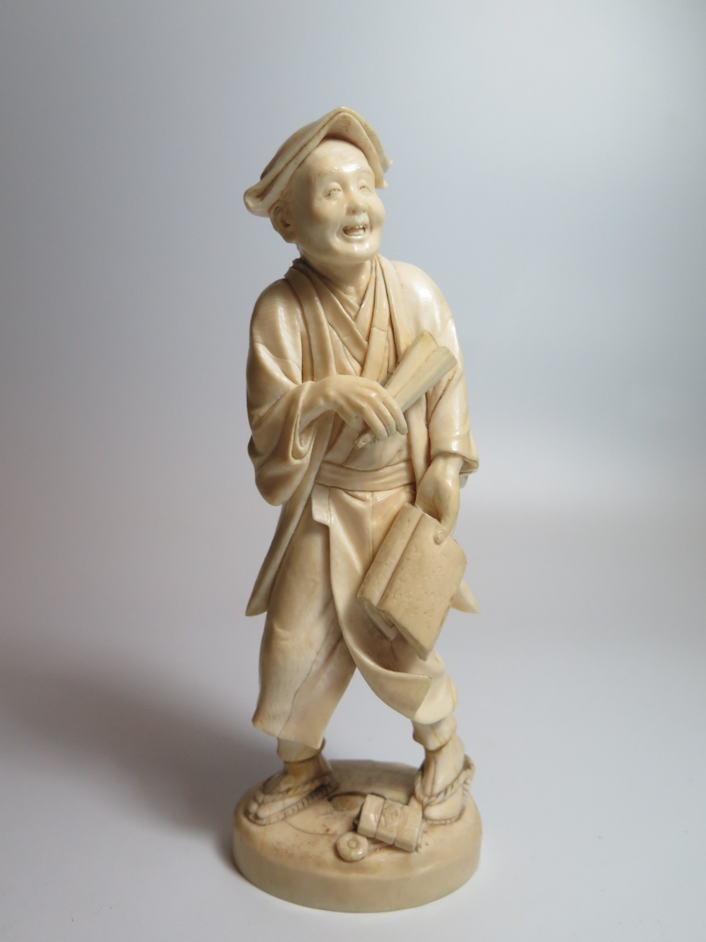 An Oriental Carved Ivory Okimono, 20cm, ankles glued