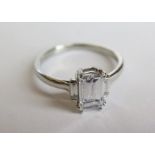 An Emerald Cut Diamond Ring with certificate: main stone 1.5ct VS2 / D, total weight 1.25ct