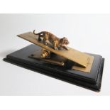 A Desk Paperclip decorated with a cold painted bronze tiger on an ebonised base, early twentieth