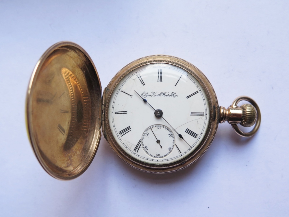 An Elgin Illionois G.M. Wheeler Keyless Full Hunter Pocket Watch with gold plated case, running,