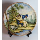 An Italian Maiolica Charger Decorated with classical scene of sleeping man about to be kissed, 33