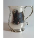 A George II Silver Christening Mug decorated with Coat of Arms and the base with pricked initials