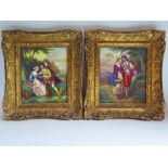 A Pair of Porcelain Plaques depicting amours in gilt frames, 18 x 15 cm