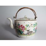 A Nineteenth Century Chinese Tea Pot with copper swing handles in original embroidered silk