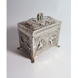 An Indian Silver Tea Caddy decorated with scenes of tigers and elephant and the hinge with