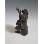 A Japanese Bronze Okimono of seated man, signature to back, 12 cm