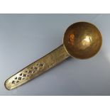 An Antique Middle Easter Brass Ladle with chased decoration and pierced handle, 22 cm