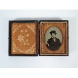 An Ambrotype Portrait of Oscar Wilde in original leather case, hinged cover loose and image damaged,