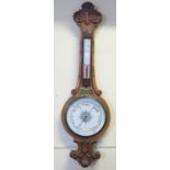 A Large Edwardian Carved Oak Banjo Barometer with thermometer, 110 cm