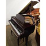 Samick (c2008) 
A grand piano in a mahogany case on square tapered legs, together with a stool.