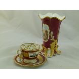 An H & R Daniel porcelain vase, with flared rim, maroon ground, and four acanthus scroll feet,