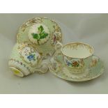 Two H & R Daniel porcelain teacups and a single saucer, Mayflower shape, the raised floral ground