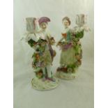 A pair of Derby 18th century porcelain figural floral encrusted candlesticks,