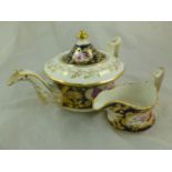 A porcelain teapot and cream jug, possibly by Ridgway, with ornate gilding, cobalt blue body and