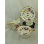 A Welsh porcelain trio and cream jug retailed by William Pardoe of Cardiff with red transfer mark to