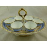 An H & R Daniel porcelain egg cup stand, second gadroon shape, with lilac blue border and gilt