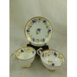 An H & R Daniel porcelain trio, plain edge shape variation C, decorated in blue and gilt with