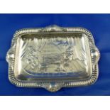A Victorian rectangular silver dish decorated with the humorous scene of Sir Walter Raleigh smoking