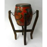 A 20th century Oriental drum with stand