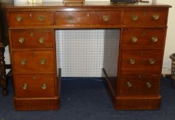 A small mahogany pedestal desk fitted with nine drawers, 105cm wide x 61cm deep