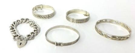 Four silver bangles t/w a silver curb link bracelet with padlock clasp, approximately 170g