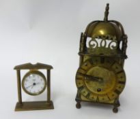 A reproduction brass lantern clock and a miniature Swiza desk clock