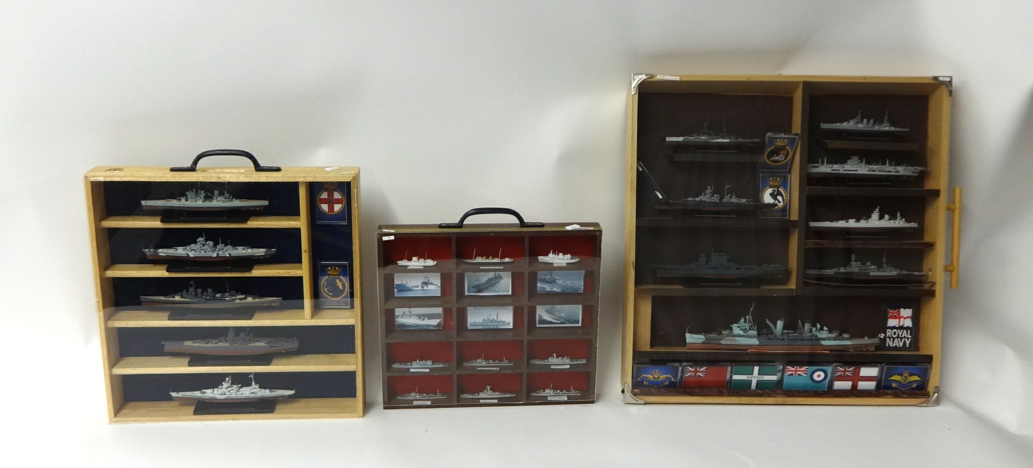 Collection of various model ships with badges (22 in three wall cases)