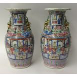 A pair of 19th century Canton porcelain baluster shaped vases with grotesque beast grips, genre
