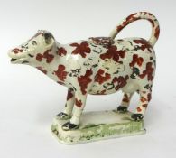 Early 19th century cream ware cow creamer, possibly Swansea, 13cm high (faults)