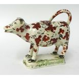 Early 19th century cream ware cow creamer, possibly Swansea, 13cm high (faults)