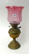 Brass oil lamp with cranberry glass shade, 45cm