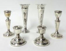 Two pairs of silver candlesticks and a pair of silver weighted spill vases (6)