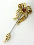 A fine 18ct ruby and diamond jabot pin set with 63 diamonds and heart shaped ruby RG Ltd, with