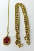 A 9ct gold long fancy link necklace, 27g yellow metal pierced ruby style pendant on chain