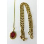 A 9ct gold long fancy link necklace, 27g yellow metal pierced ruby style pendant on chain